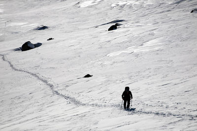 Hiker climbing snowcapped mountain