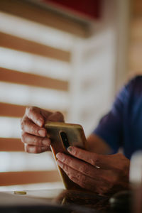 Man using mobile phone at table