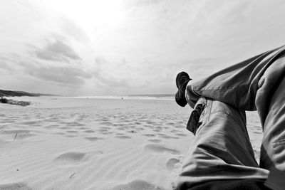 Man on beach against sky