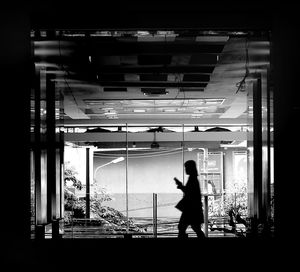 Full length of woman standing on railing