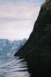 Scenic view of sea and mountains against sky