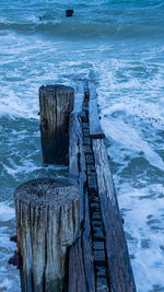 High angle view of wooden post on beach