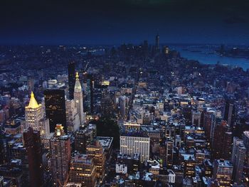 Aerial view of city lit up at night