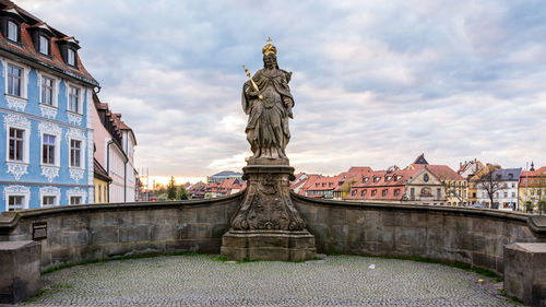 Low angle view of statue against cloudy sky