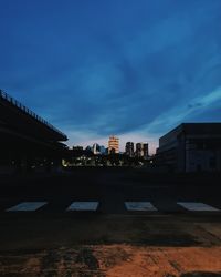 Illuminated buildings against sky at night