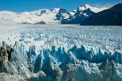 Panoramic view of snowcapped mountains against sky