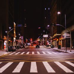 Illuminated city street at night