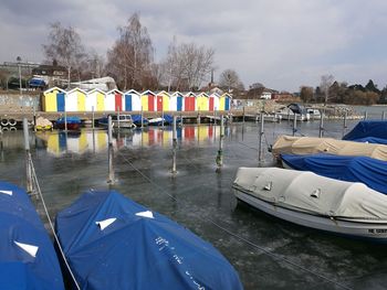 Boats moored in sea against sky