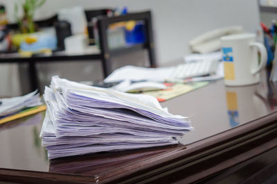 Close-up of paper stack desk at office