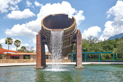 View of fountain in lake against building