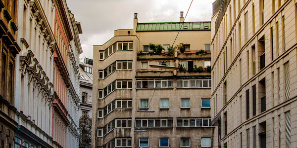 Low angle view of buildings in town against sky