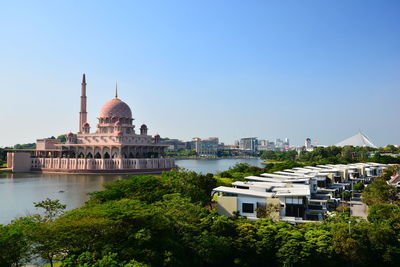 Putra mosque by river against clear sky