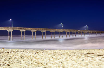 Low angle view of bridge against clear blue sky