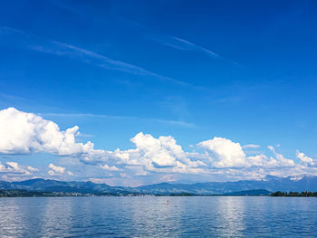 Scenic view of sea against blue sky