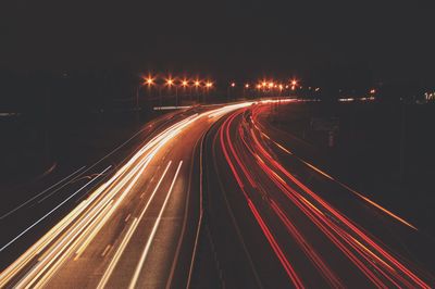 High angle view of light trails on road at night