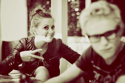 Portrait of young couple sitting in restaurant