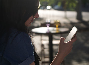 Side view of woman using smart phone