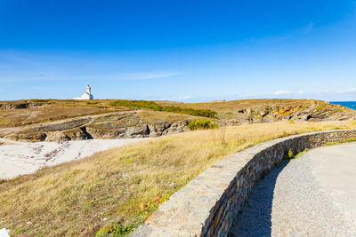 Scenic view of land against blue sky