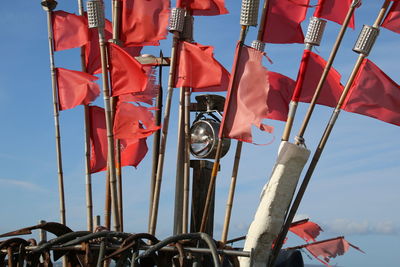 Low angle view of flags hanging against sky