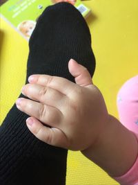 Close-up of cropped hand holding cigarette