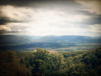 Scenic view of mountains against cloudy sky