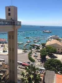 High angle view of city by sea against clear sky