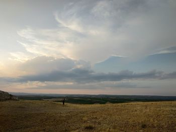 Scenic view of field against sky during sunset