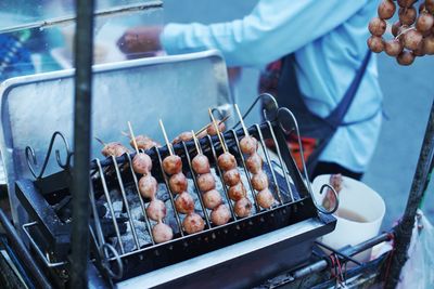 Man preparing food on barbecue grill