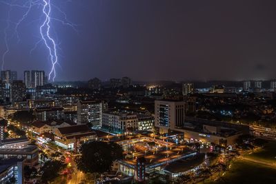 Aerial view of illuminated cityscape against sky at night