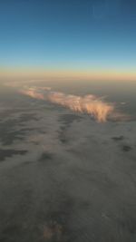 Aerial view of sea against sky during sunset