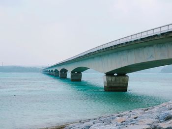 Bridge over sea against sky