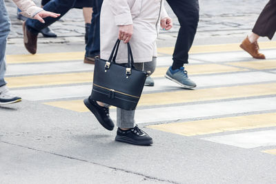 Low section of people walking on road