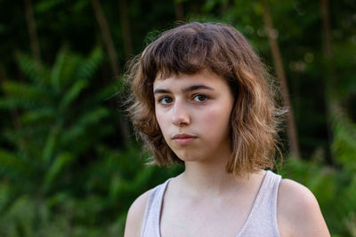 Serious teenager girl with curly hair 