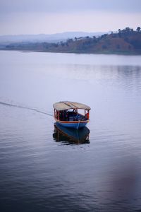 Boat in lake against sky