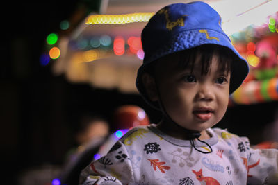 Close-up of cute baby boy at night