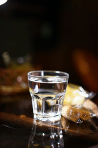 Glass with drinking water on the night cafe table