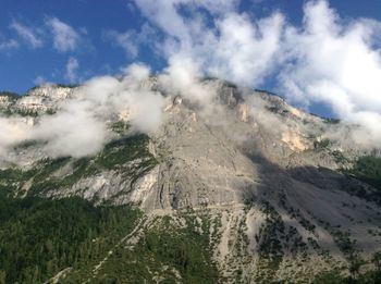 Scenic view of mountains against cloudy sky