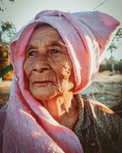 Close-up portrait of a serious young woman outdoors