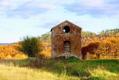 Old ruin on field against sky