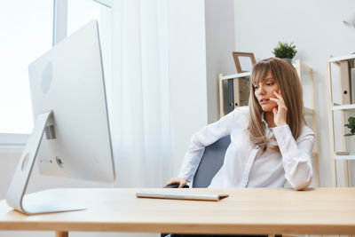 Businesswoman working at desk in office