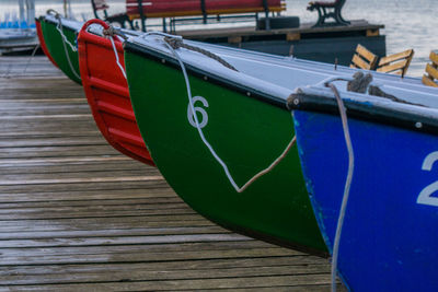 Boats moored on pier at harbor