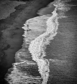 High angle view of woman walking on tbe beach alone