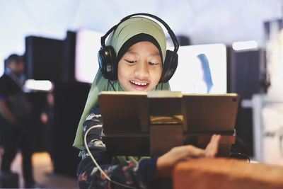 Portrait of happy boy using mobile phone