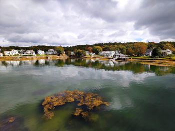 Scenic view of lake by building against sky