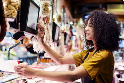 Female owner using desktop computer in shop