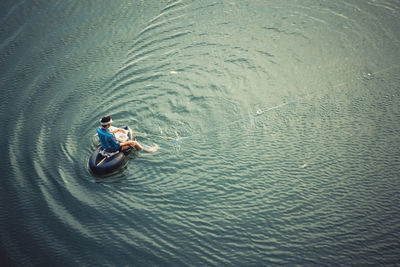 High angle view of man fishing in river