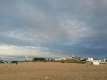 Lighthouse against cloudy sky