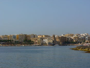 City by sea against sky