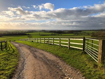 Farm track and fences in rural landscape , late afternoon light, kingsdon, somerset, england