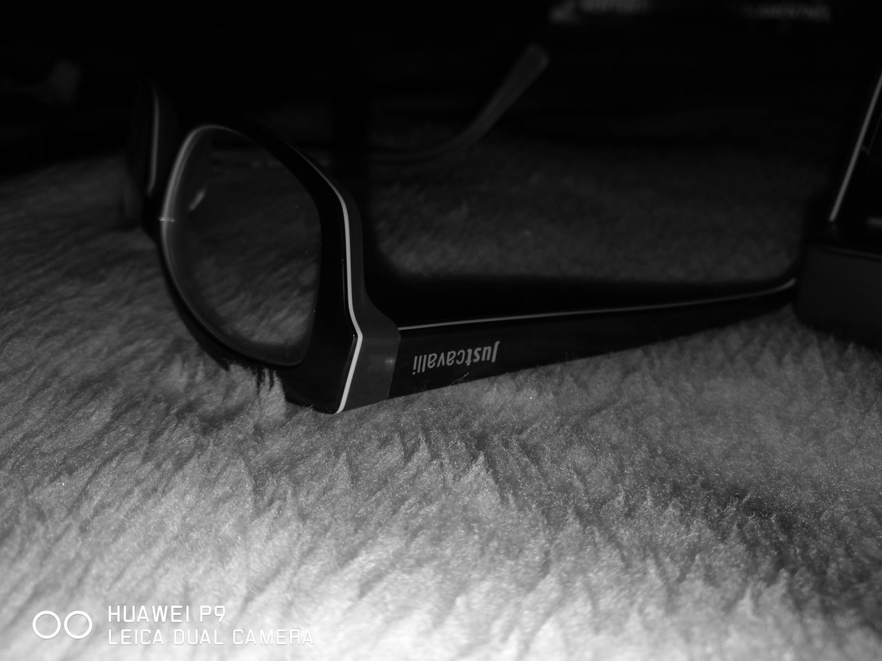 CLOSE-UP OF EYEGLASSES ON TABLE WITH TEXT